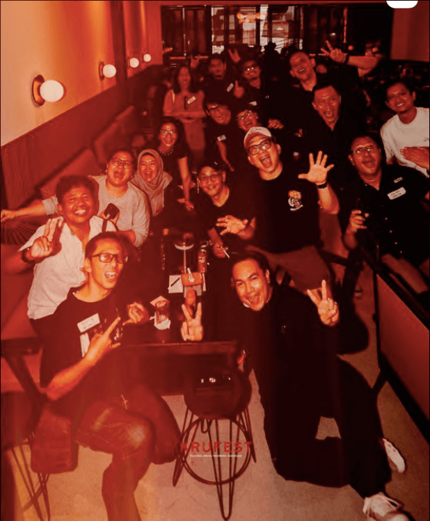 KRUFEST community gathering -- production crew members posing together in a warm, cinematic setting